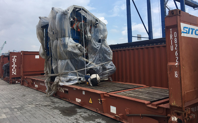 Vận chuyển cont flatrack: cụm máy bọc nilon chằng buộc trên container Flat Rack