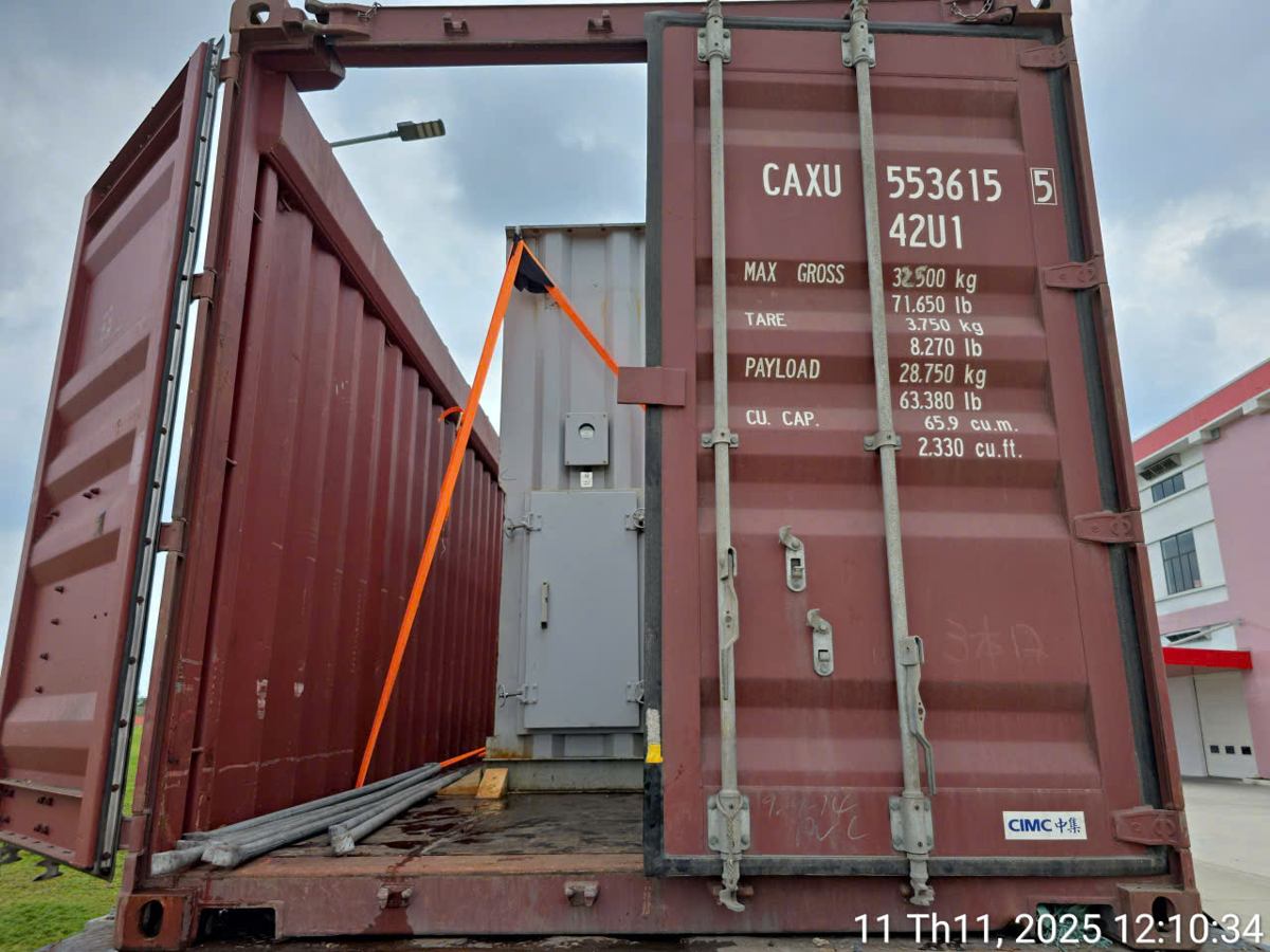 Open top container with crated machinery lashed inside, trucked to Cat Lai port Vietnam