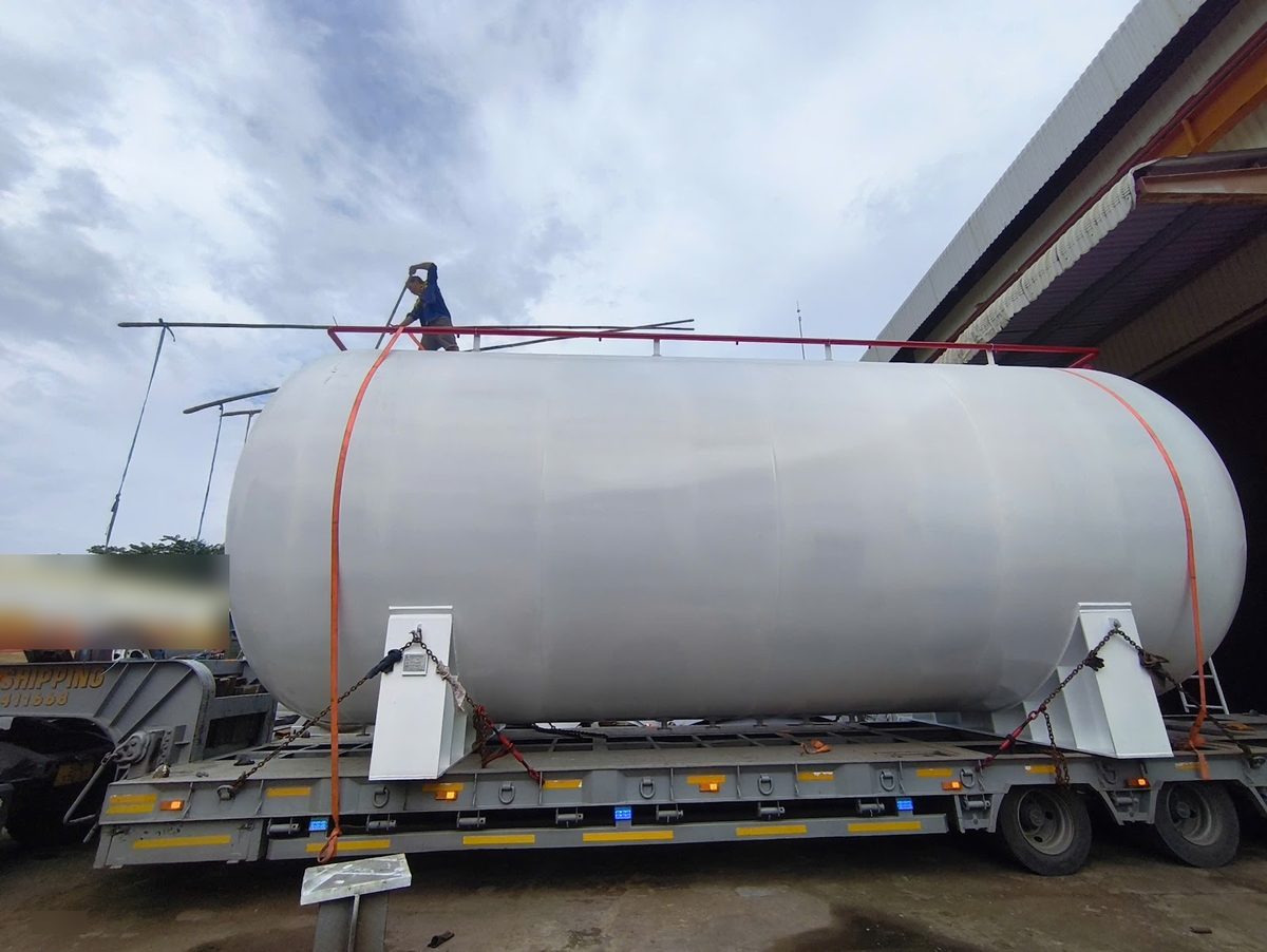 Storage tank chained to its saddles on a lowbed before a Vietnam Cambodia transit run to Moc Bai