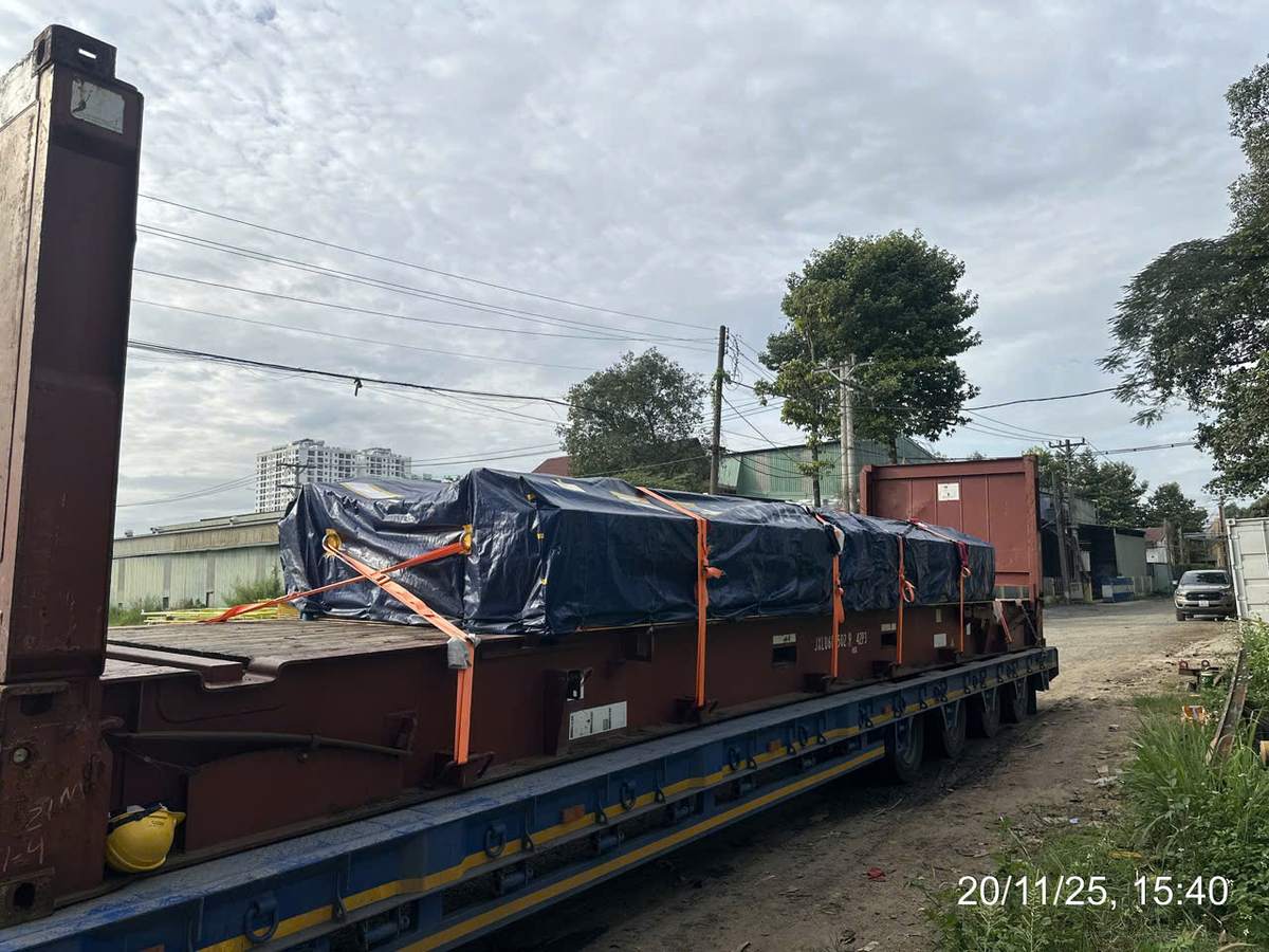 Mooc chở cont 40 flat rack có hàng bọc bạt chằng đai trong sân bãi Bình Dương