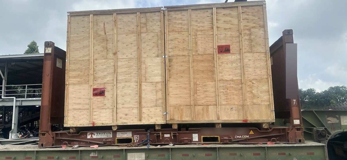 Wooden crates on 20ft flat racks loaded on a trailer after pick-up from Cat Lai port
